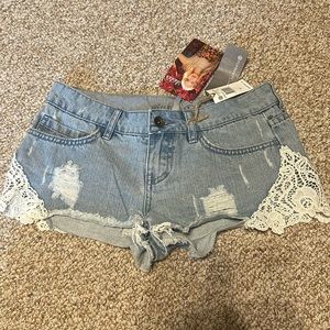 NWT! Lulus distressed denim shorts. Size 24. Lace detail and pinstripe pockets.